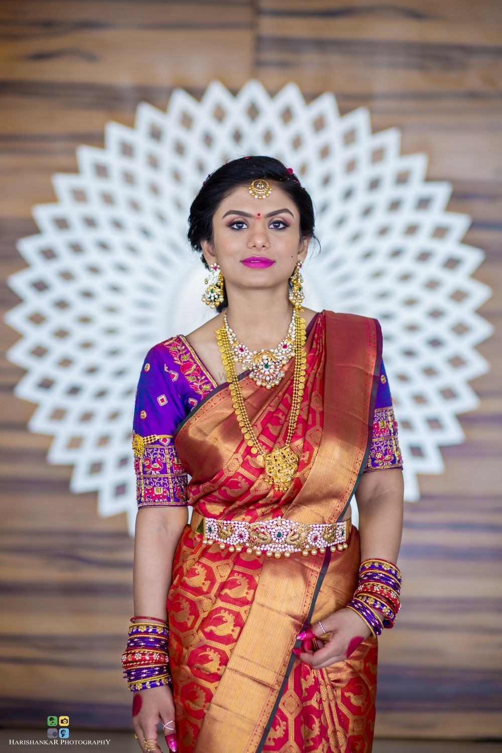 Photo of Bridal saree in red and gold with purple blouse