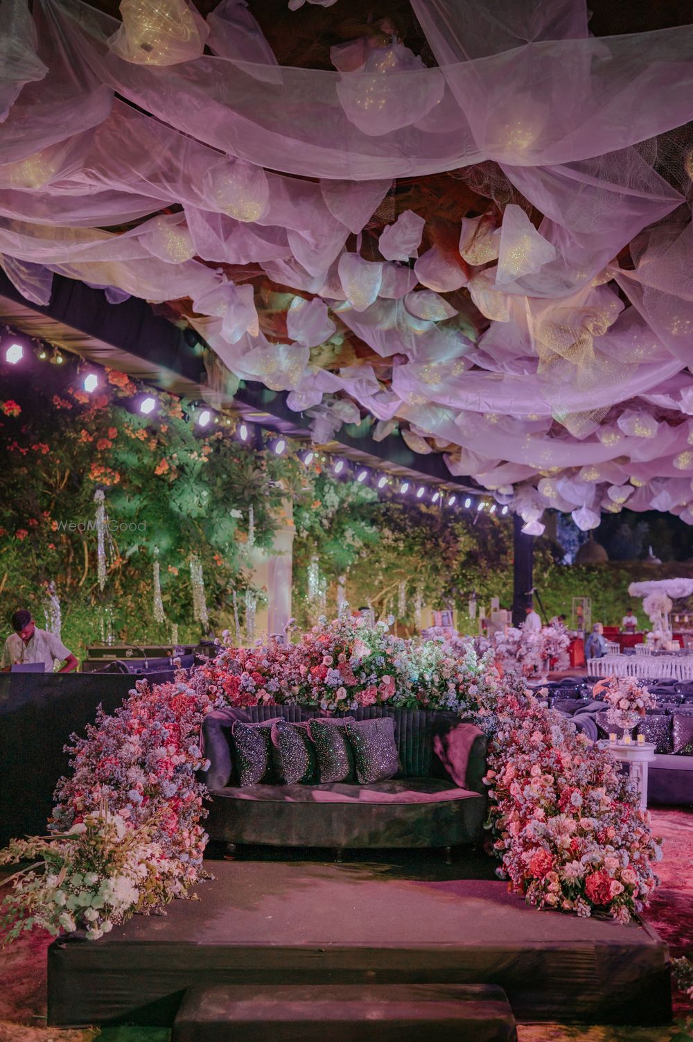 Photo of Unique seating decor with a floating ceiling and florals around the sofa