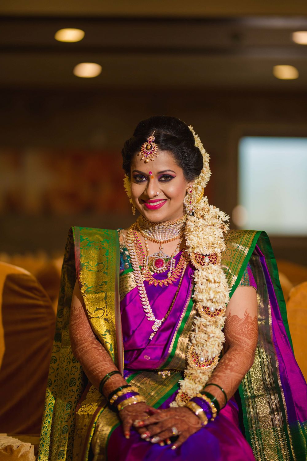 Photo of South Indian bride with floral braid hairstyle and kanjivaram saree