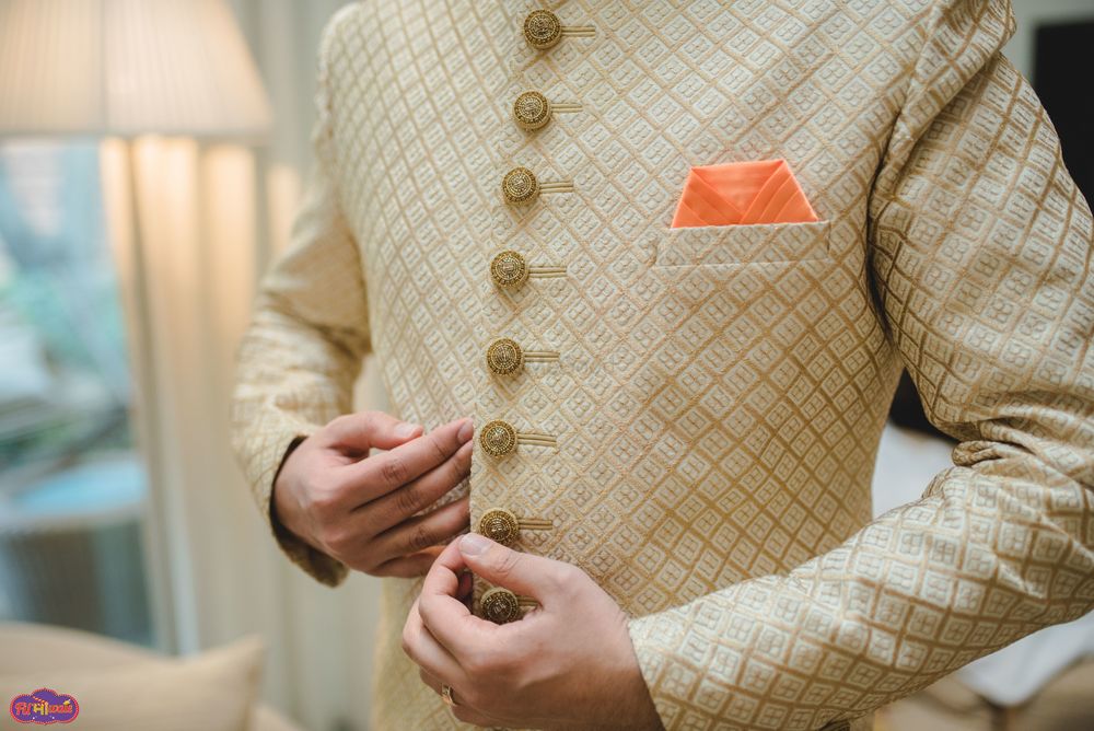 Photo of Checked cream and gold sherwani with buttons