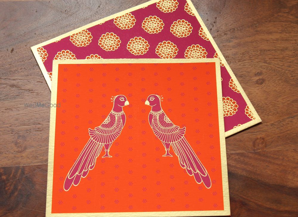 Photo of orange and maroon invitations