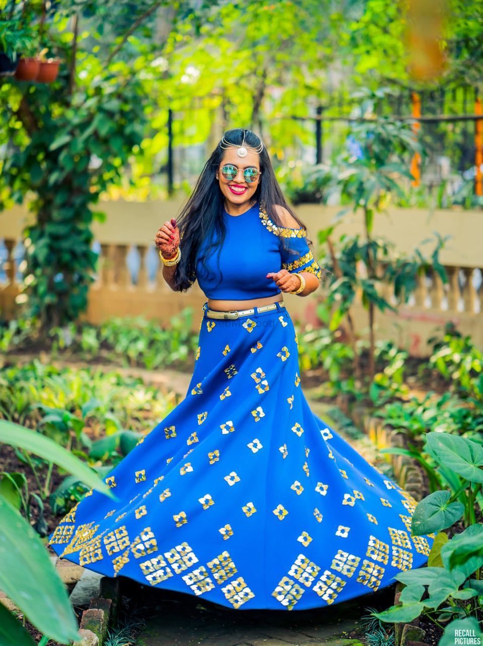 Photo of Happy bride in a blue lehenga twirling