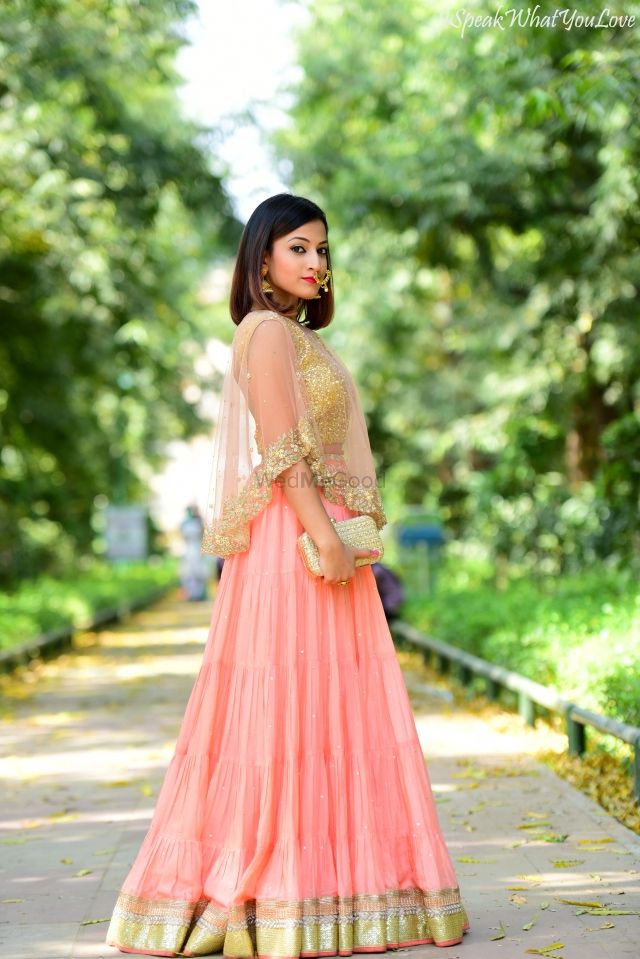 Photo of Peach and Gold Lehenga with Gold Clutch