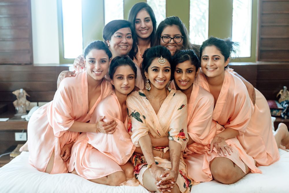 Photo of Bride and bridesmaids in peach robes
