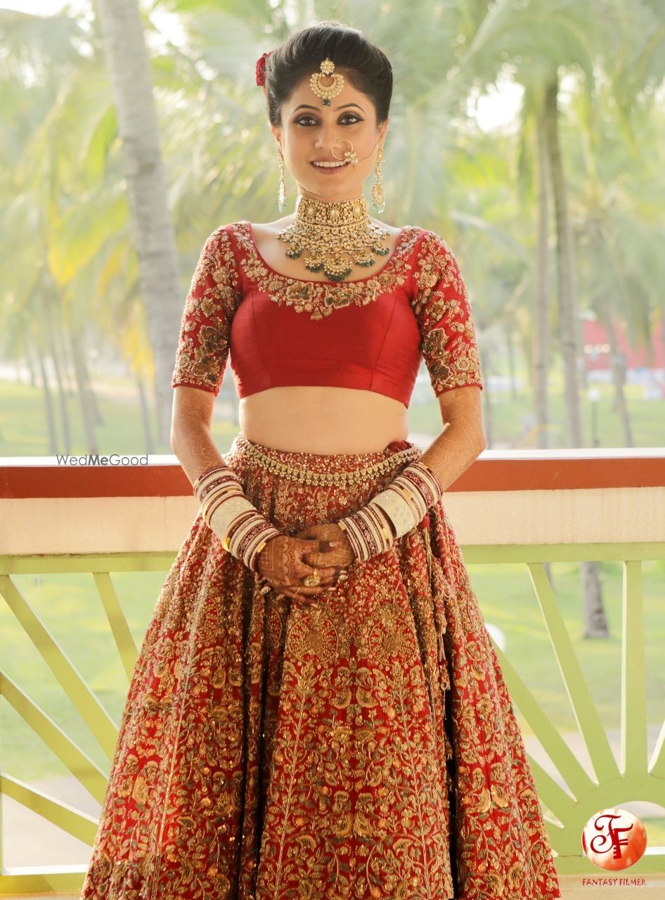 Photo of Getting ready shot with bride in blouse and lehenga