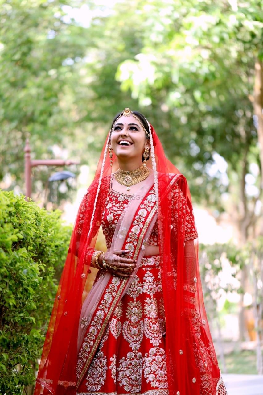 Photo of Red and pink bridal lehenga with happy bride