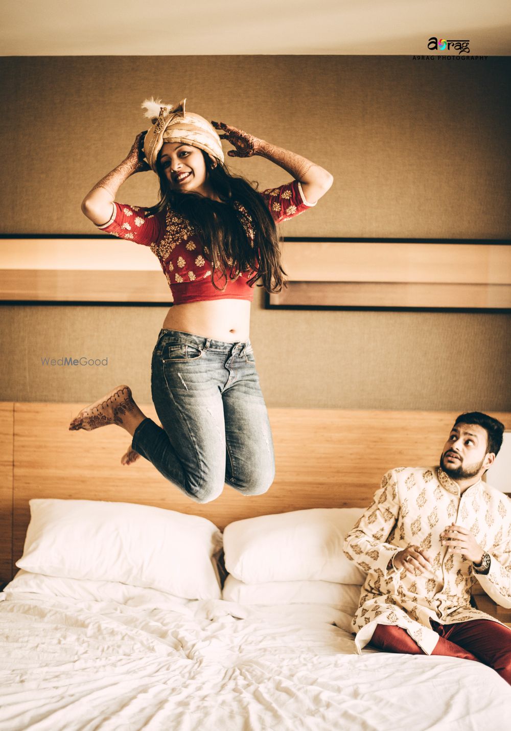 Photo of Cute couple getting ready shot with bride jumping