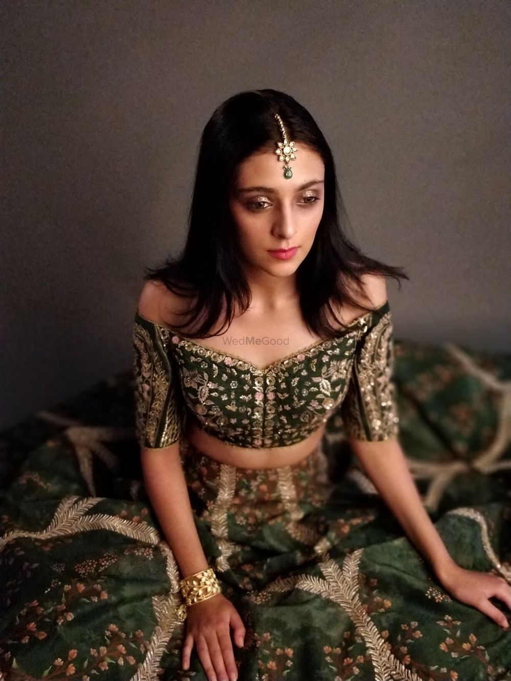 Photo of Off shoulder forest green lehenga for the sister of the bride or groom