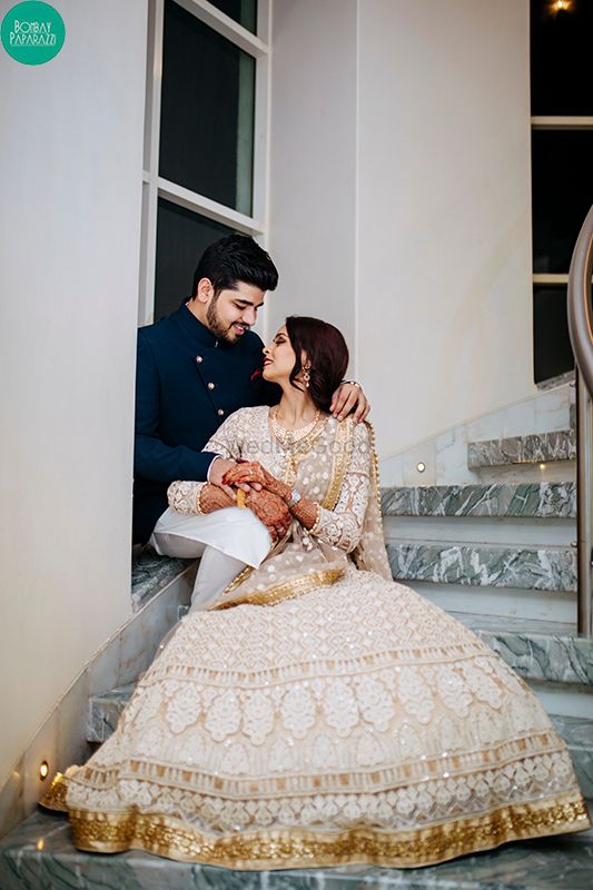 Photo of Stunning couple portrait with bride in white and gold lehenga
