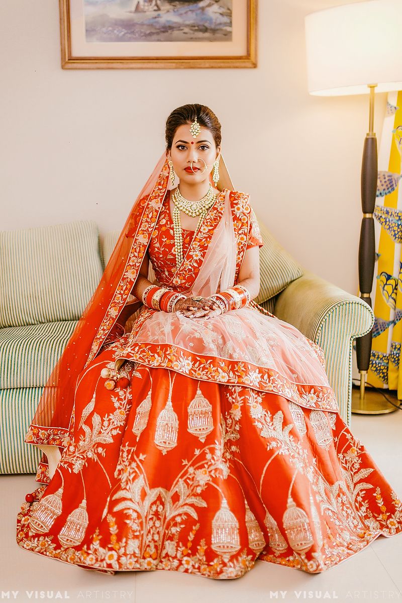 Photo of Lehenga with birdcage motif in red and gold