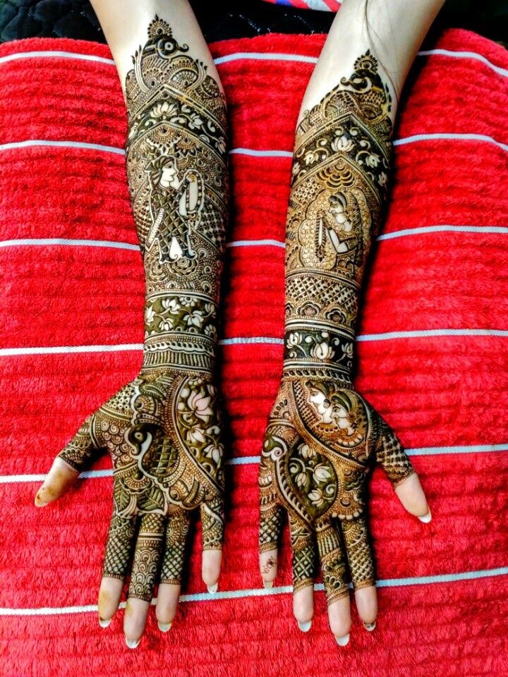Photo of Stunning intricate bridal mehendi with lotus motif and bride and groom caricatures