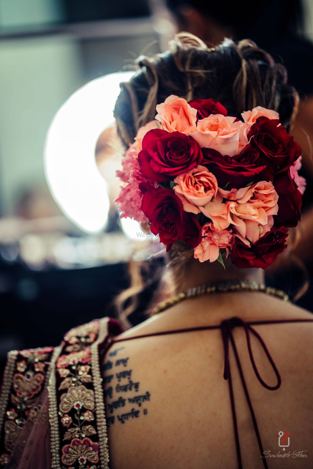 Photo of Offbeat bridal bun with big flowers