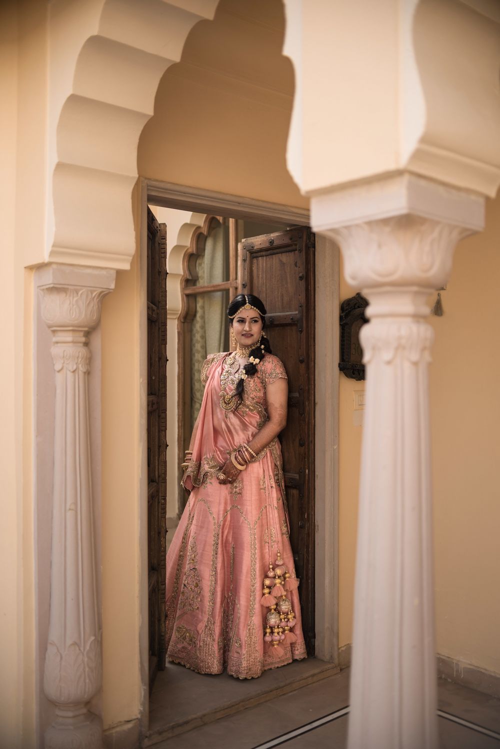 Photo of Simple baby pink and gold lehenga with triangle drape
