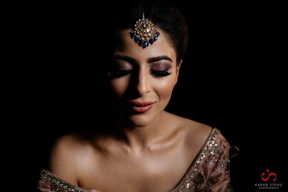 Photo of Bride with bold brows and dark brown smokey eyes