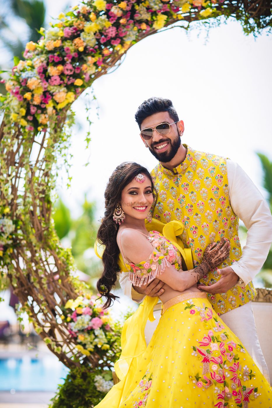 Photo of Mehendi bride and groom look in yellow outfits