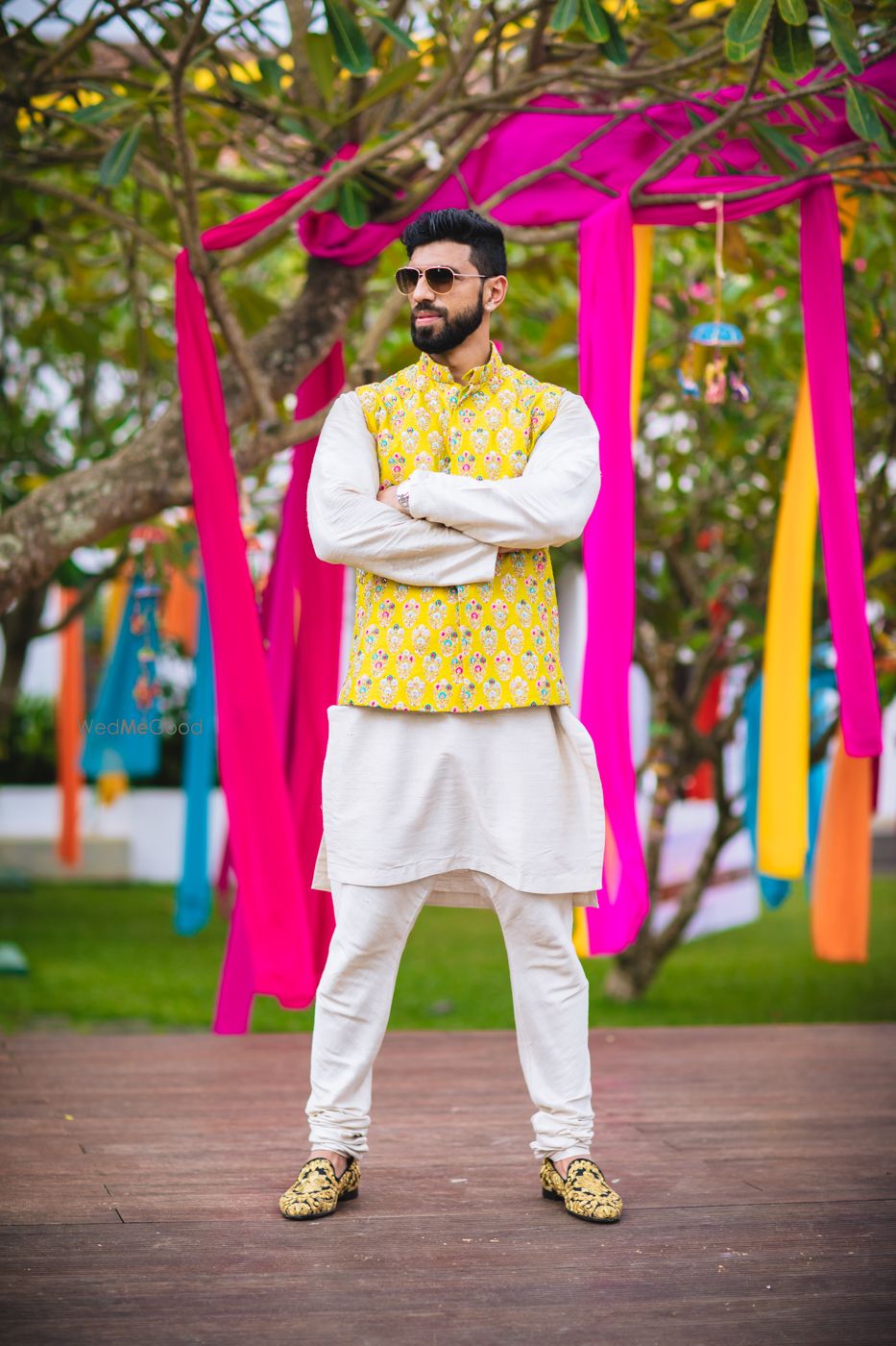 Photo of Quirky mehendi groomwear with yellow jacket over kurta