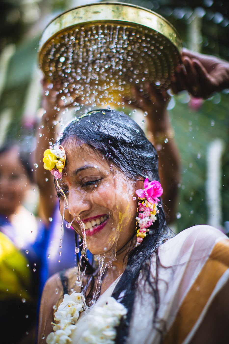 Photo of Bridal portait with water pouring on haldi