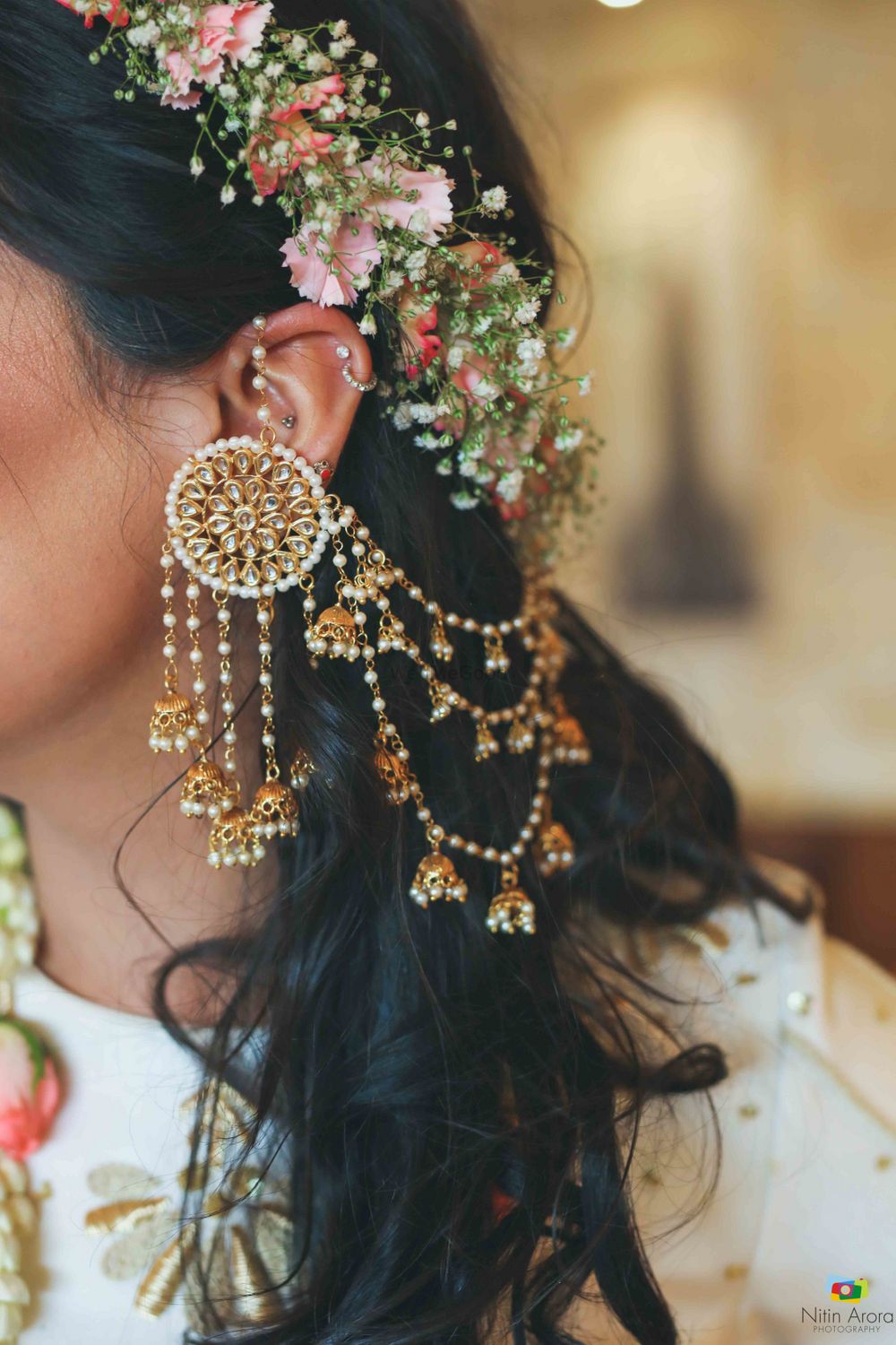 Photo of Pretty floral tiara on head with gold jhumkis