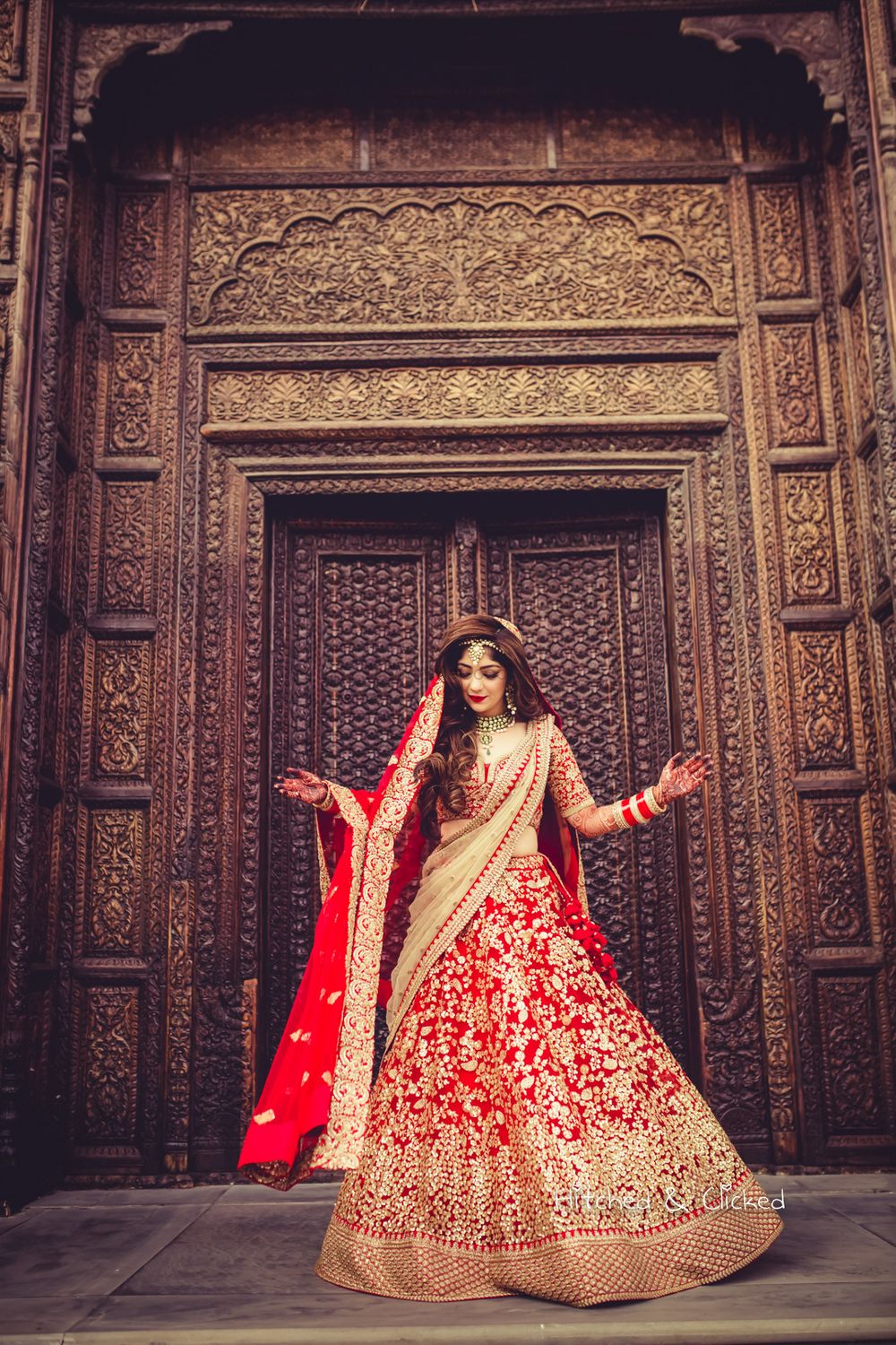 Photo of Bride with red and gold lehenga and open hair