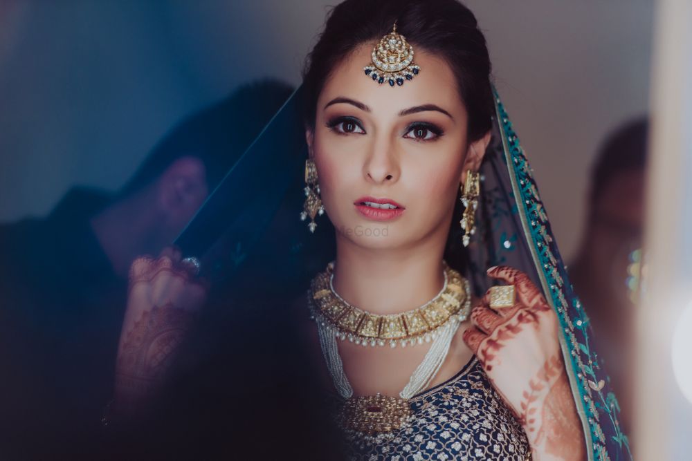 Photo of Bride wearing pearl jewellery with blue lehenga