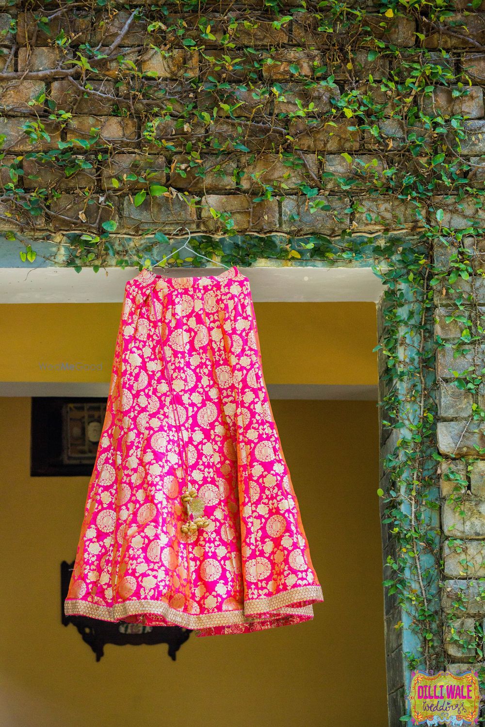 Photo of Bright pink benarasi lehenga on hanger