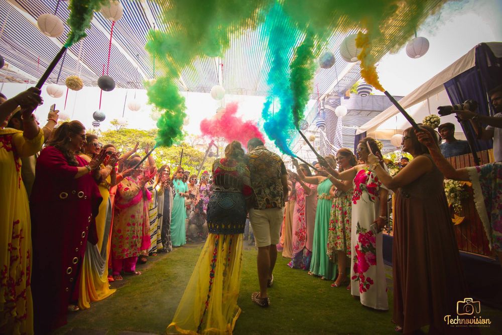 Photo of Mehendi entry idea with guests holding smoke sticks