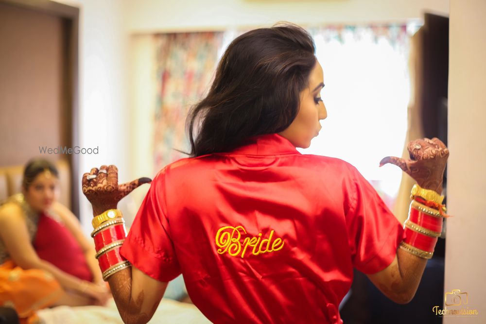 Photo of Bride showing off red robe