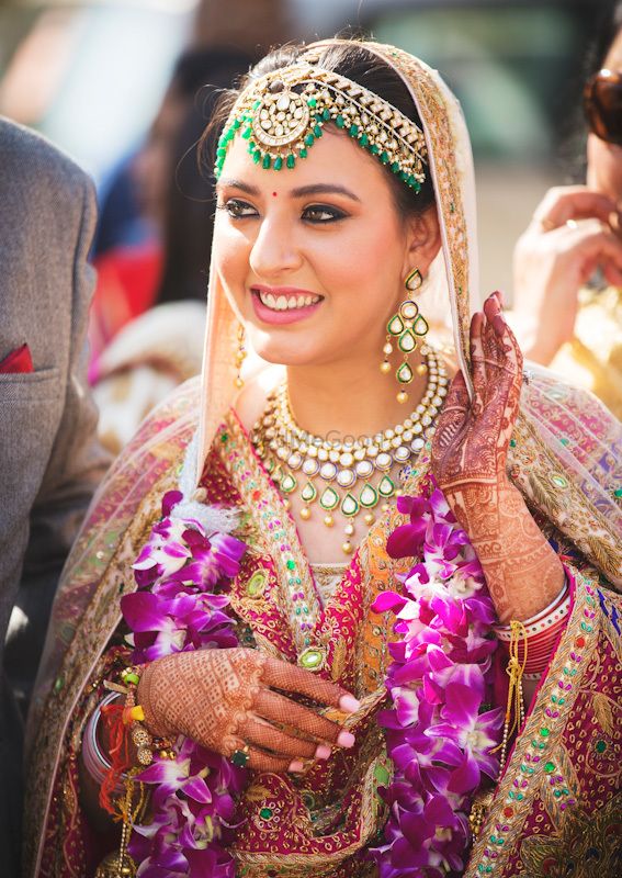 Photo of Happy bride shot in green Kundan jewellery