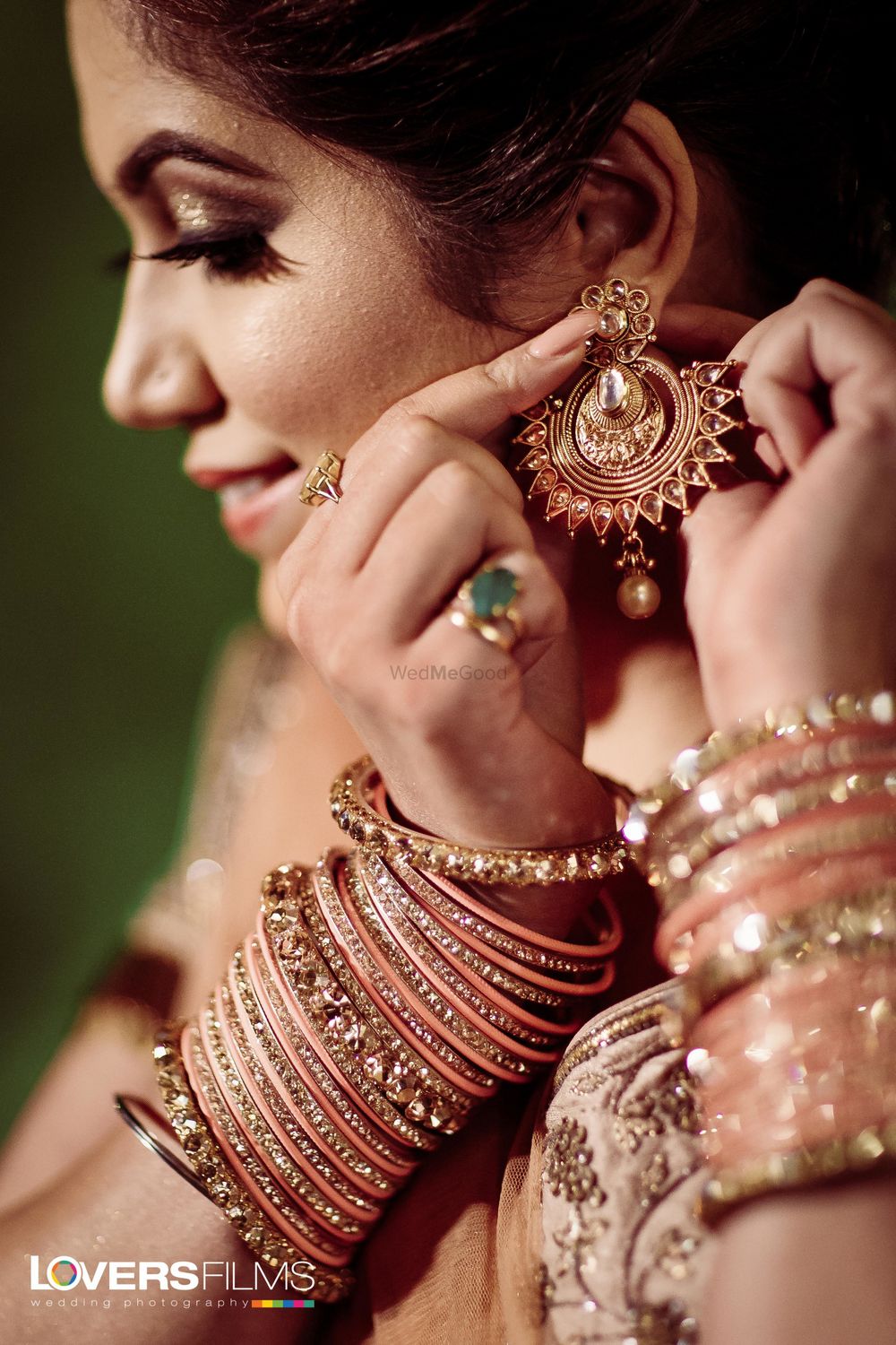 Photo of Bride wearing her earrings and bangles