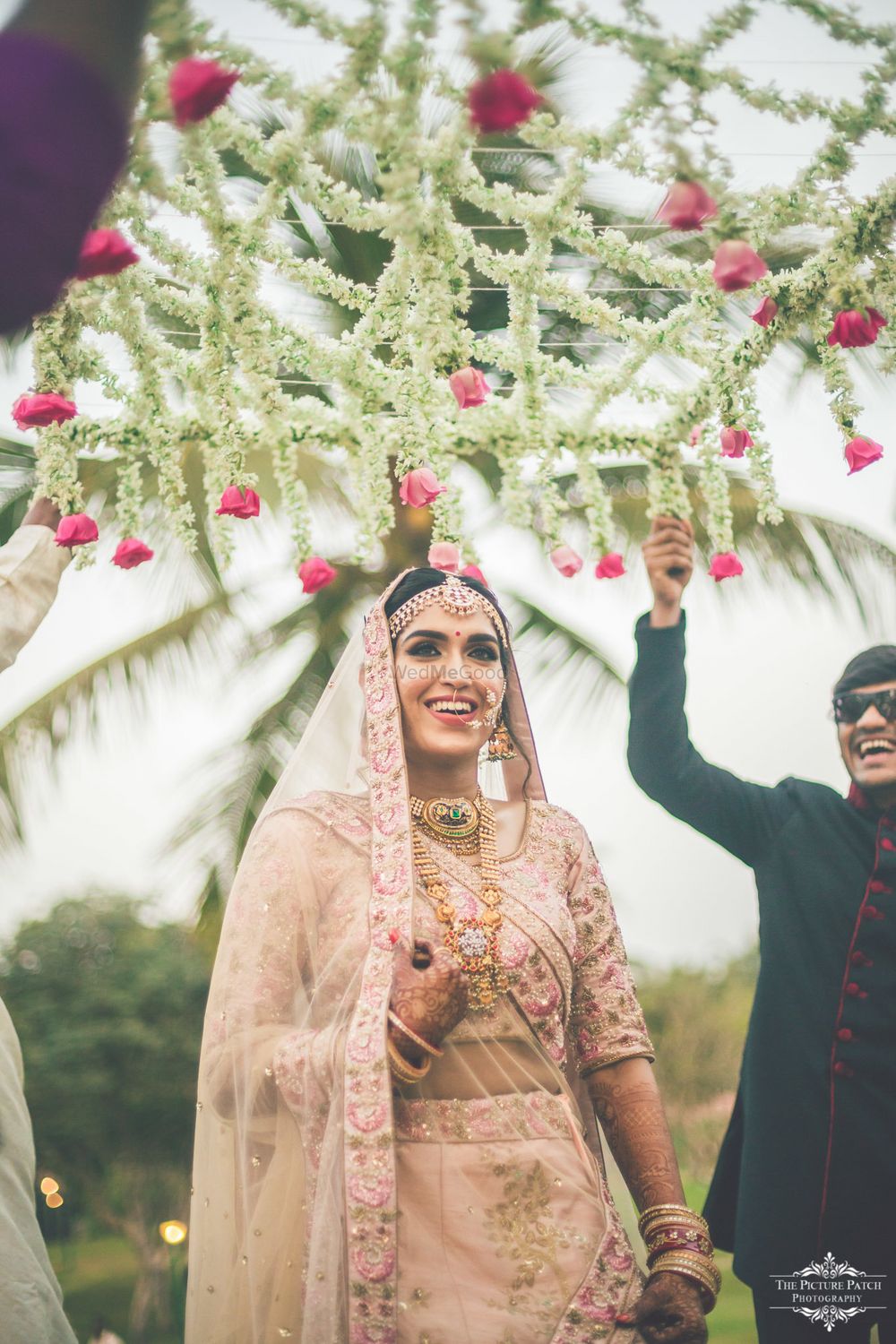 Photo of Smiling bride under phoolon ki chadar