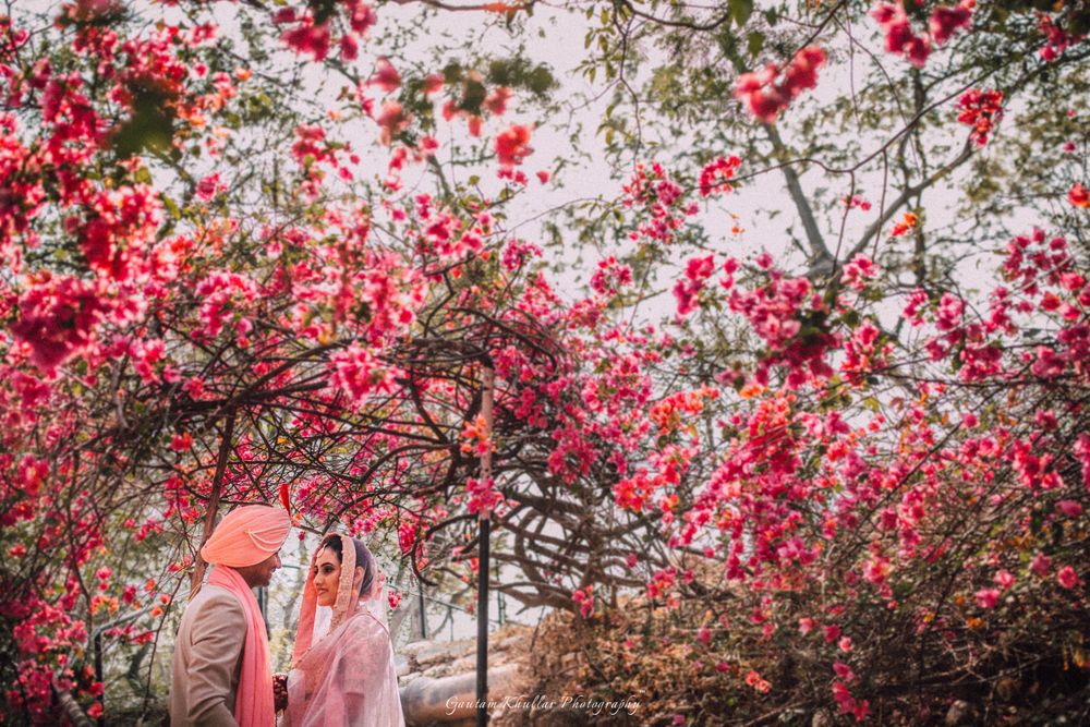 Photo of Couple shot against outdoor floral backdrop
