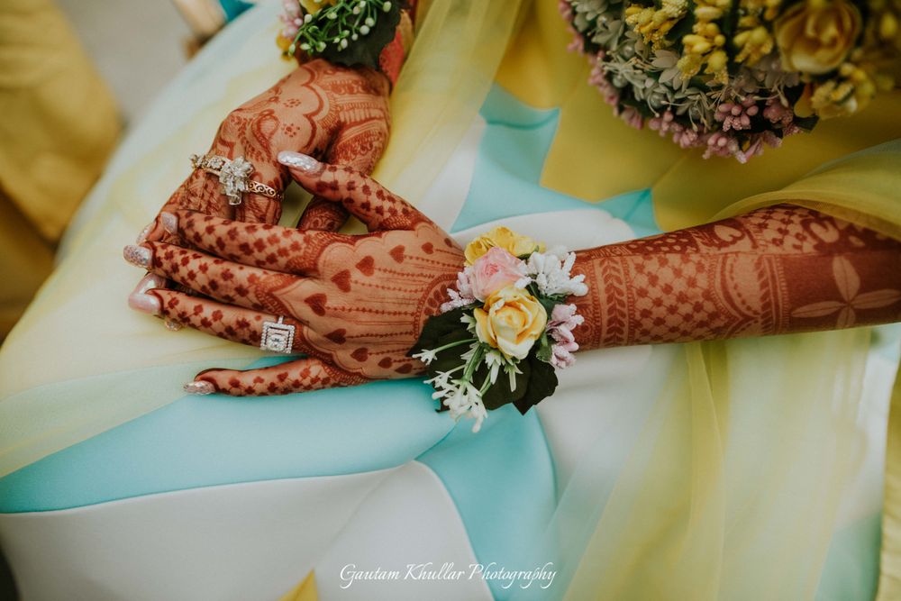 Photo of Bridal corsage on hands with engagement ring