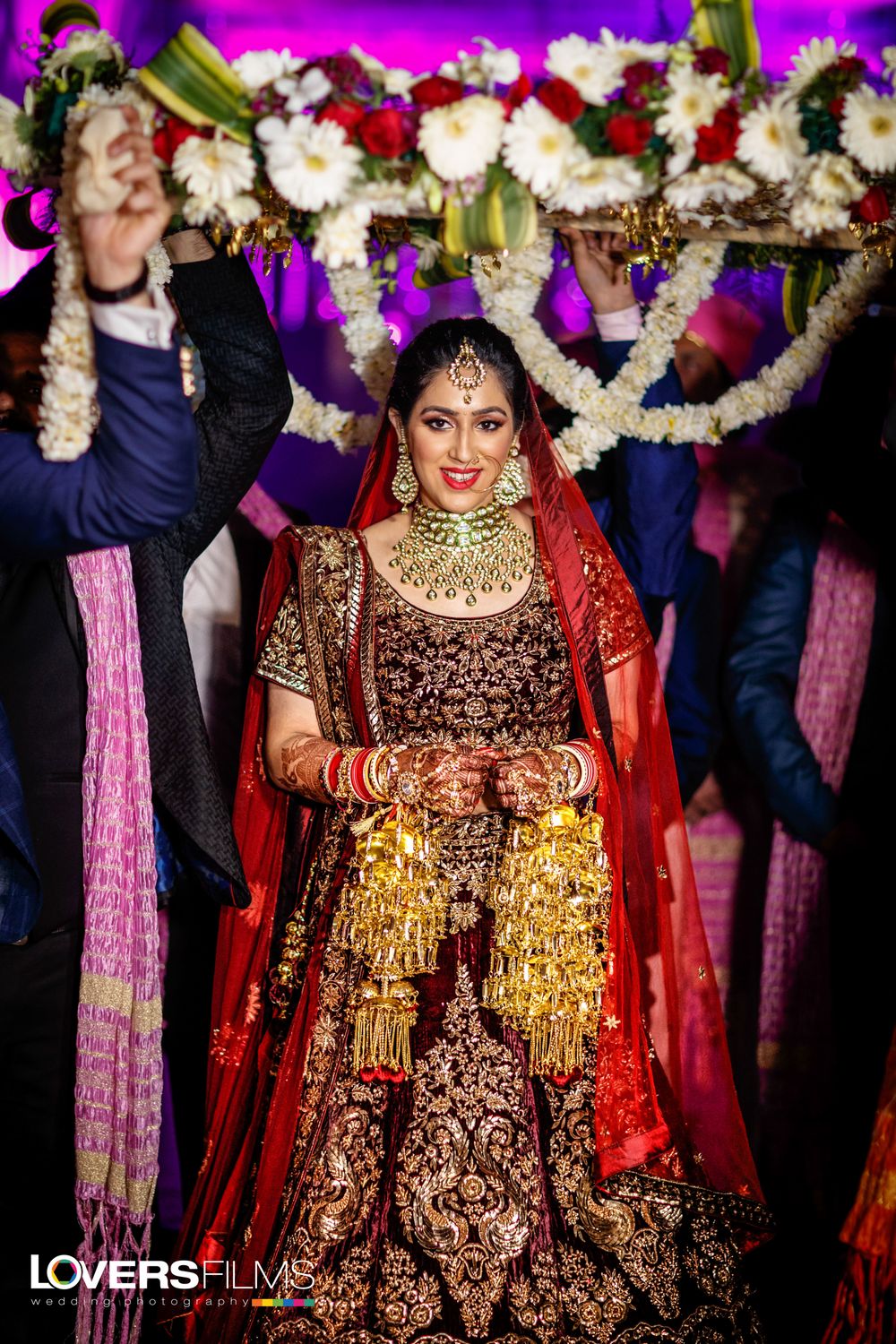 Photo of Heavy maroon bridal lehenga with gold embroidery