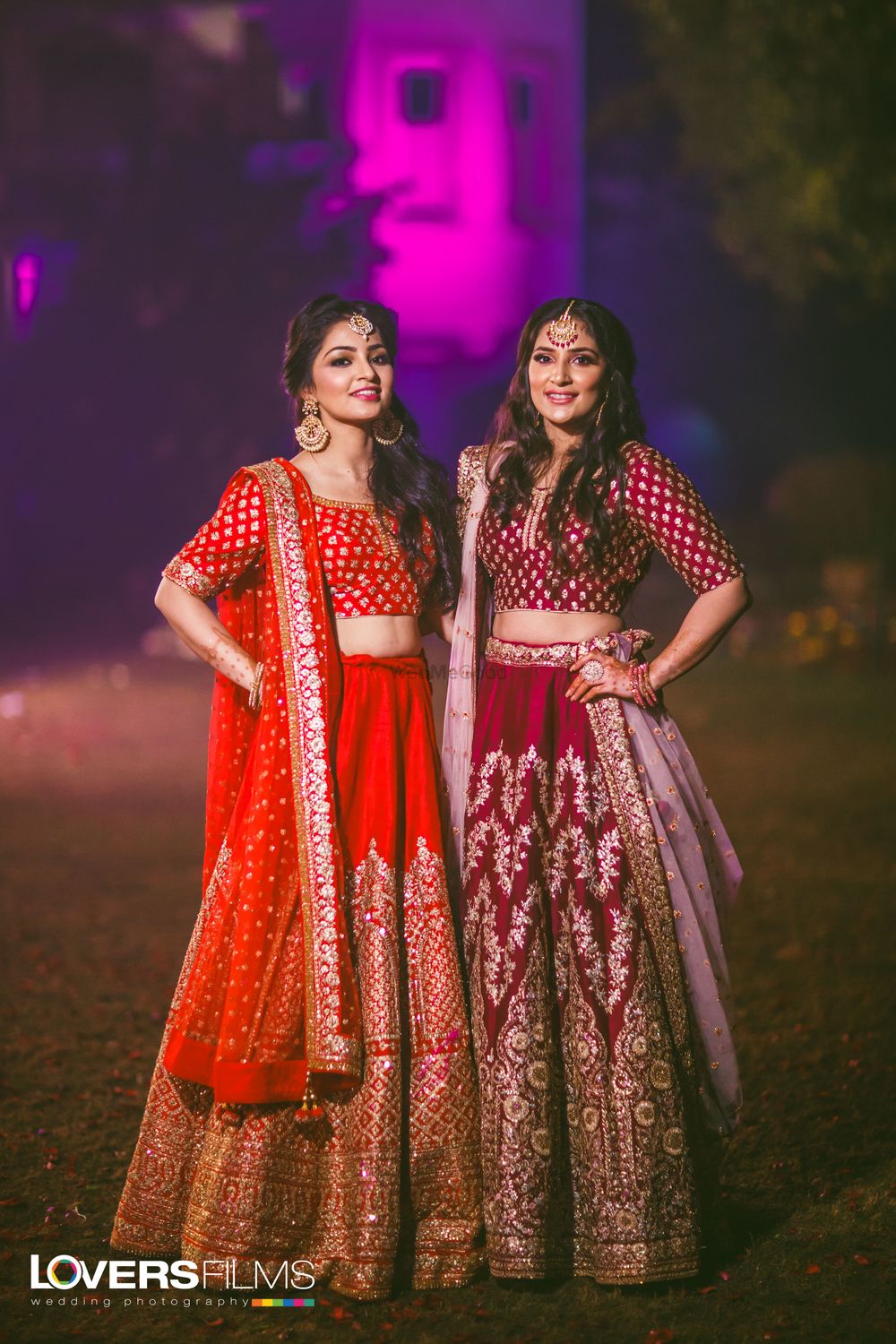 Photo of Sisters of the bride in red and maroon lehengas