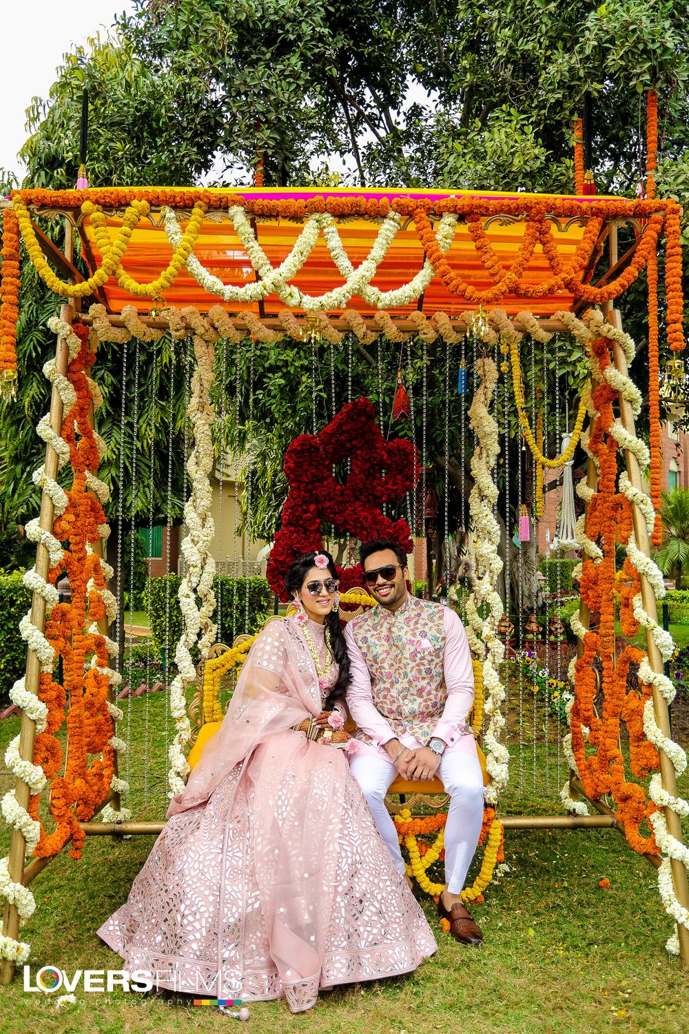 Photo of Light pink mehendi lehenga and matching groomwear