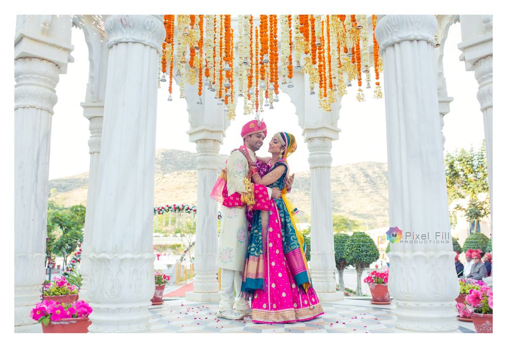 Photo of Destination wedding couple photo in bright bridal lehenga