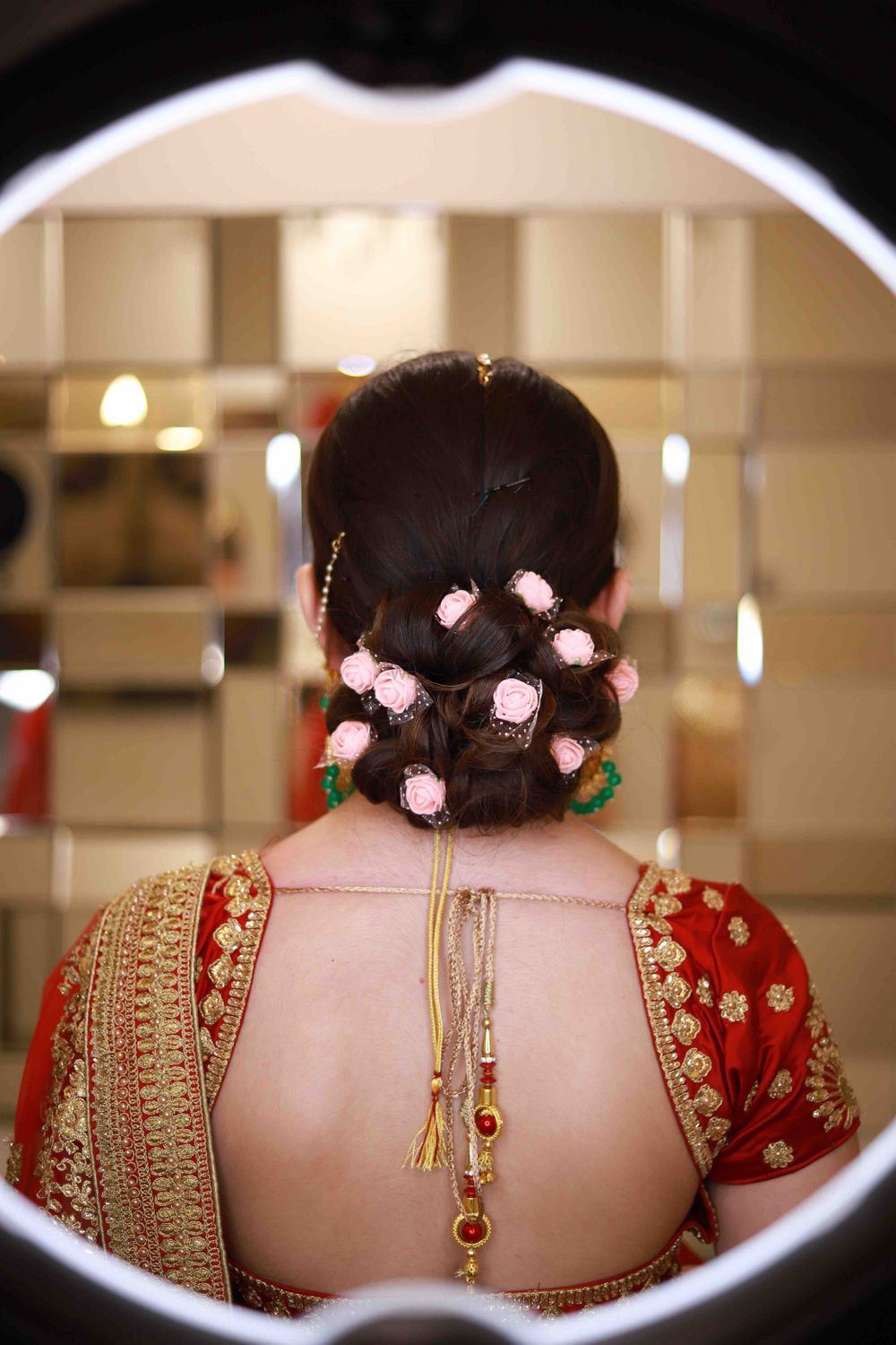 Photo of Bridal bun with flowers small roses