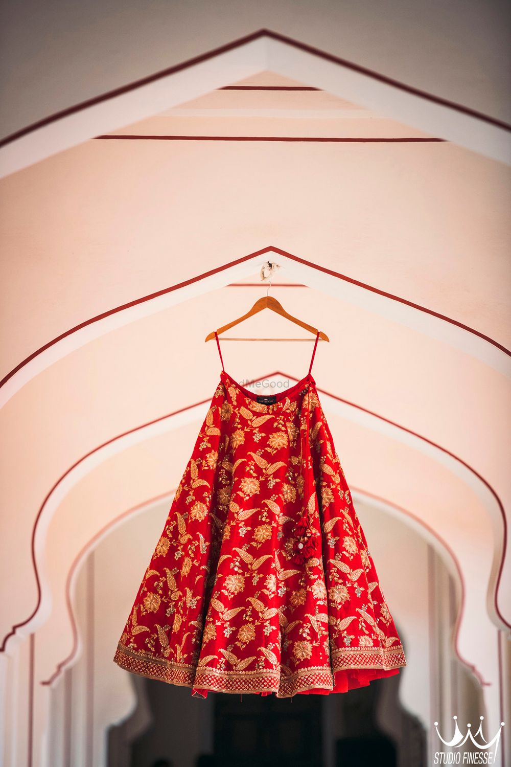 Photo of Red and gold Sabyasachi bridal lehenga on hanger