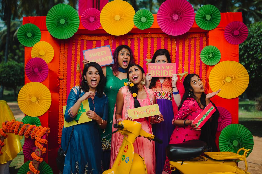 Photo of Bride with bridesmaids in mehendi photobooth