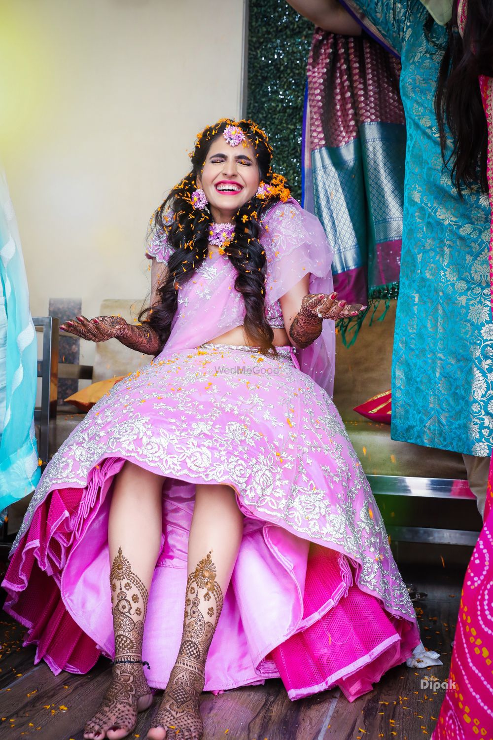 Photo of Bride on mehendi with petal shower