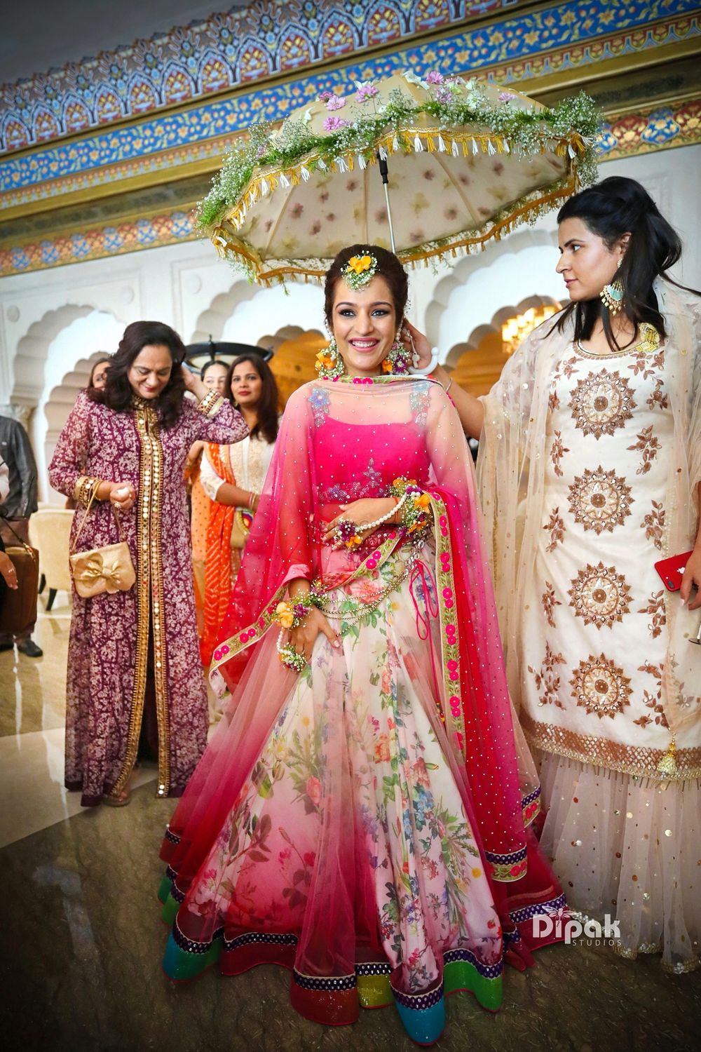 Photo of Bright pink mehendi lehenga bridal entry shot