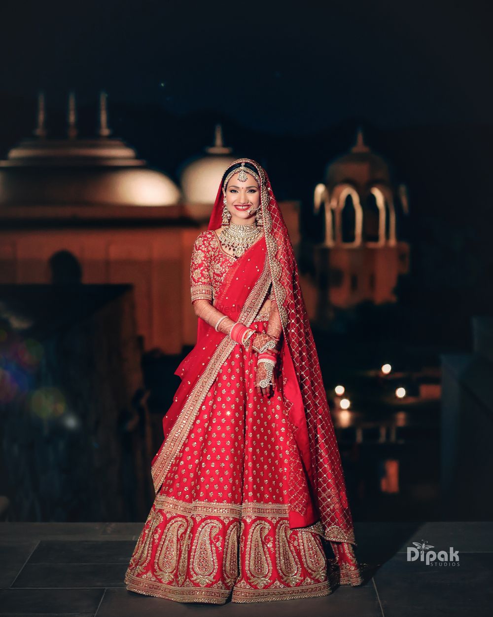 Photo of A beautiful bridal shot in a heavy red bridal lehenga.