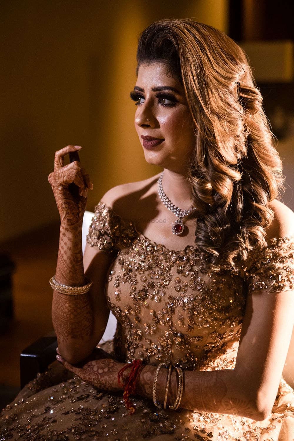 Photo of A bride to be sits pretty in a gold gown