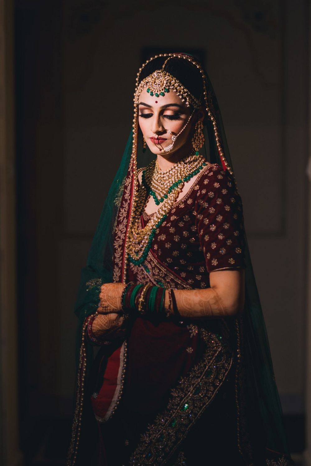 Photo of Bride with contrasting jewellery and deep lehenga