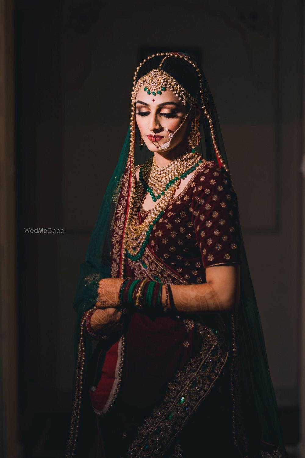 Photo of Bride with contrasting jewellery and deep lehenga