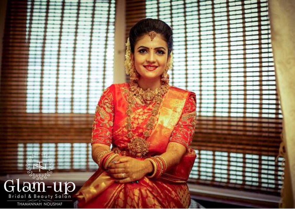 Photo of A south indian bride in red kanjeevaram saree and temple jewellery