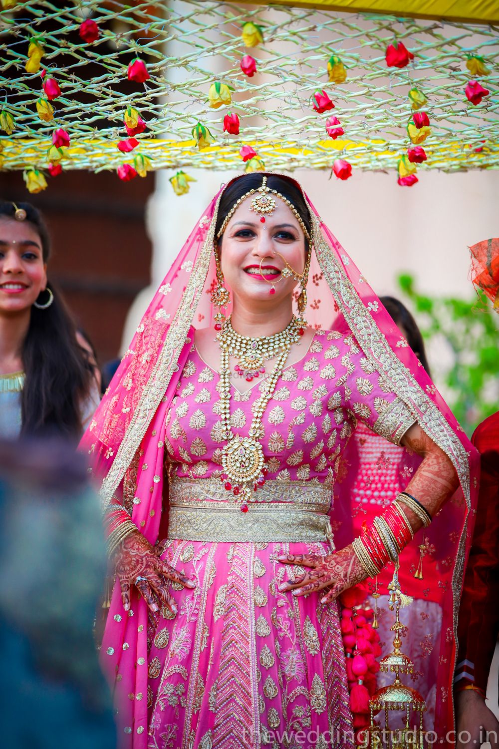 Photo of Bride entering in bright pink lehenga