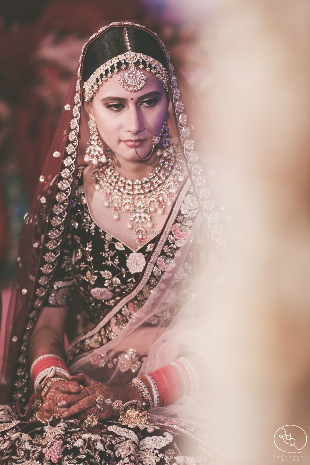 Photo of Dark bridal lehenga with pretty jewellery