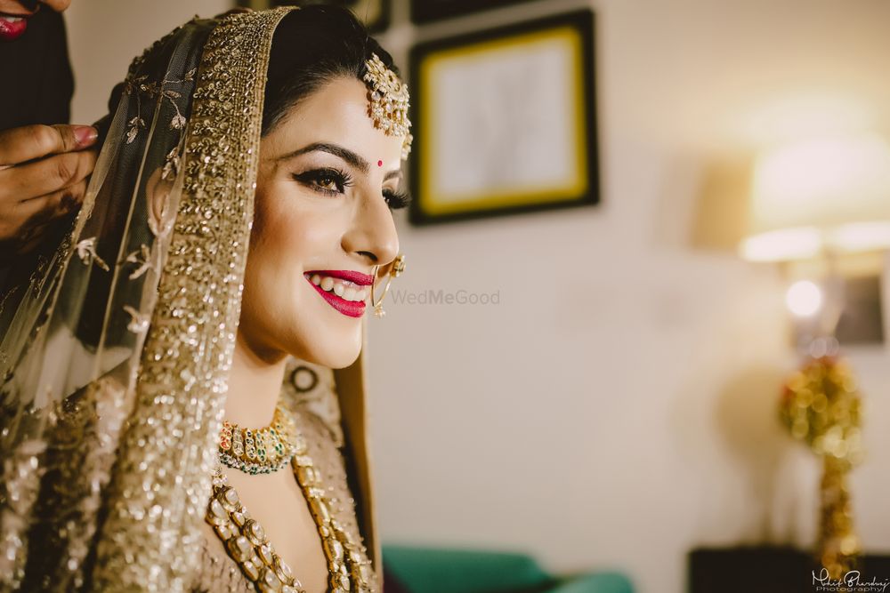 Photo of Bridal portrait in gold with red makeup