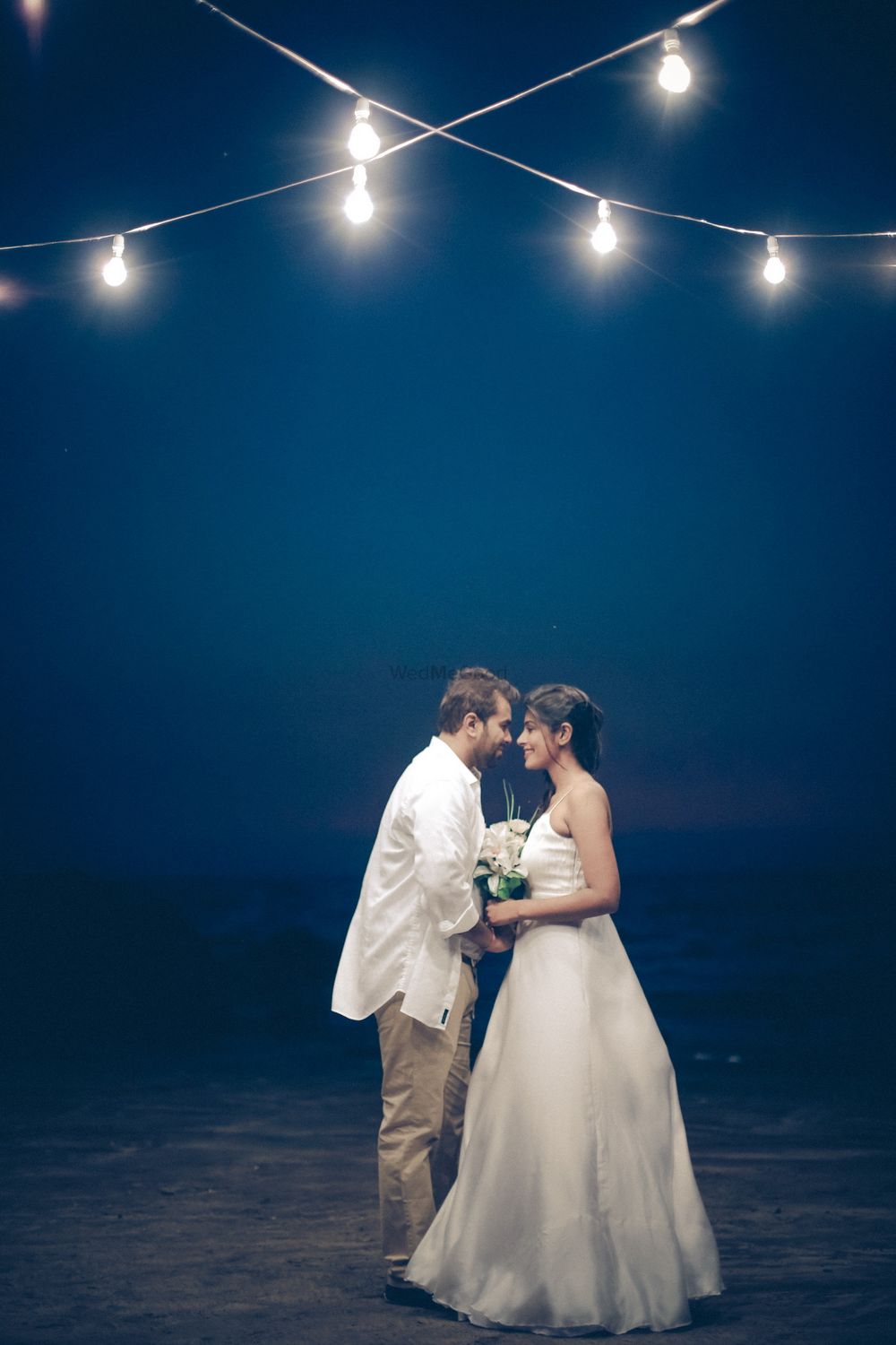 Photo of Cute couple portrait with fairy lights